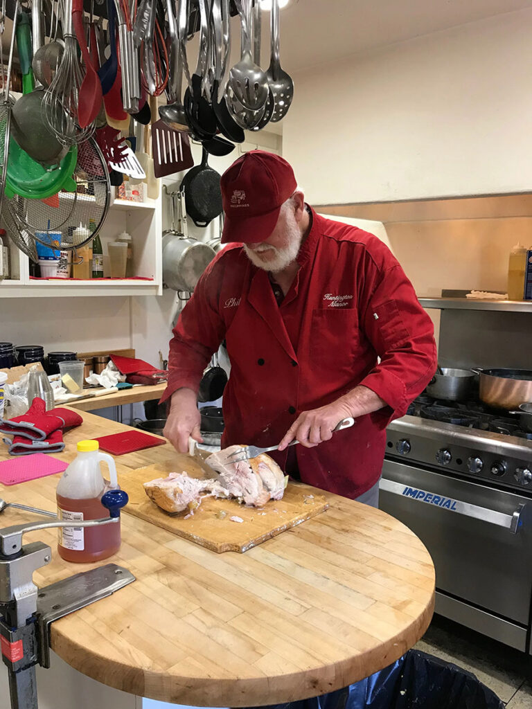 Chef Philip cutting the meat for dinner