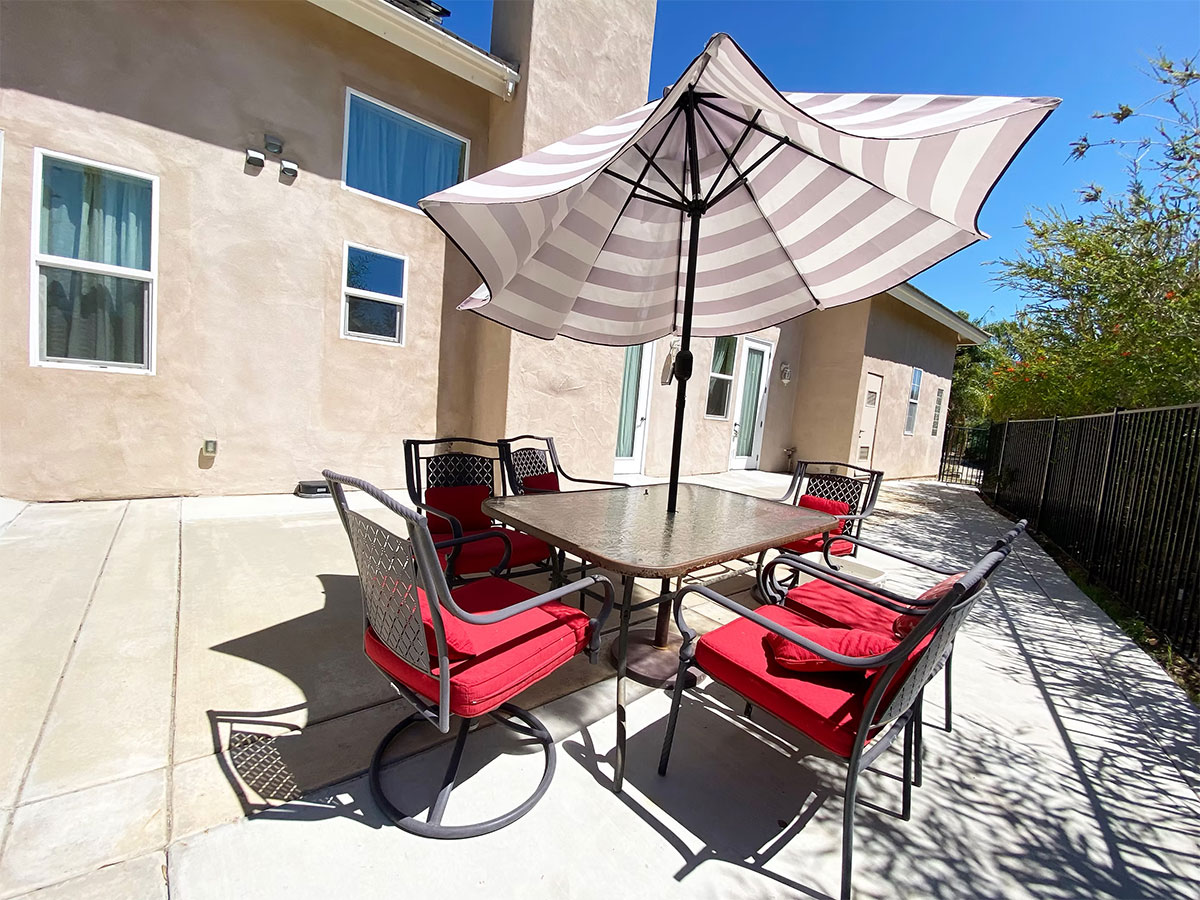 Patio with table, chairs and sun umbrella